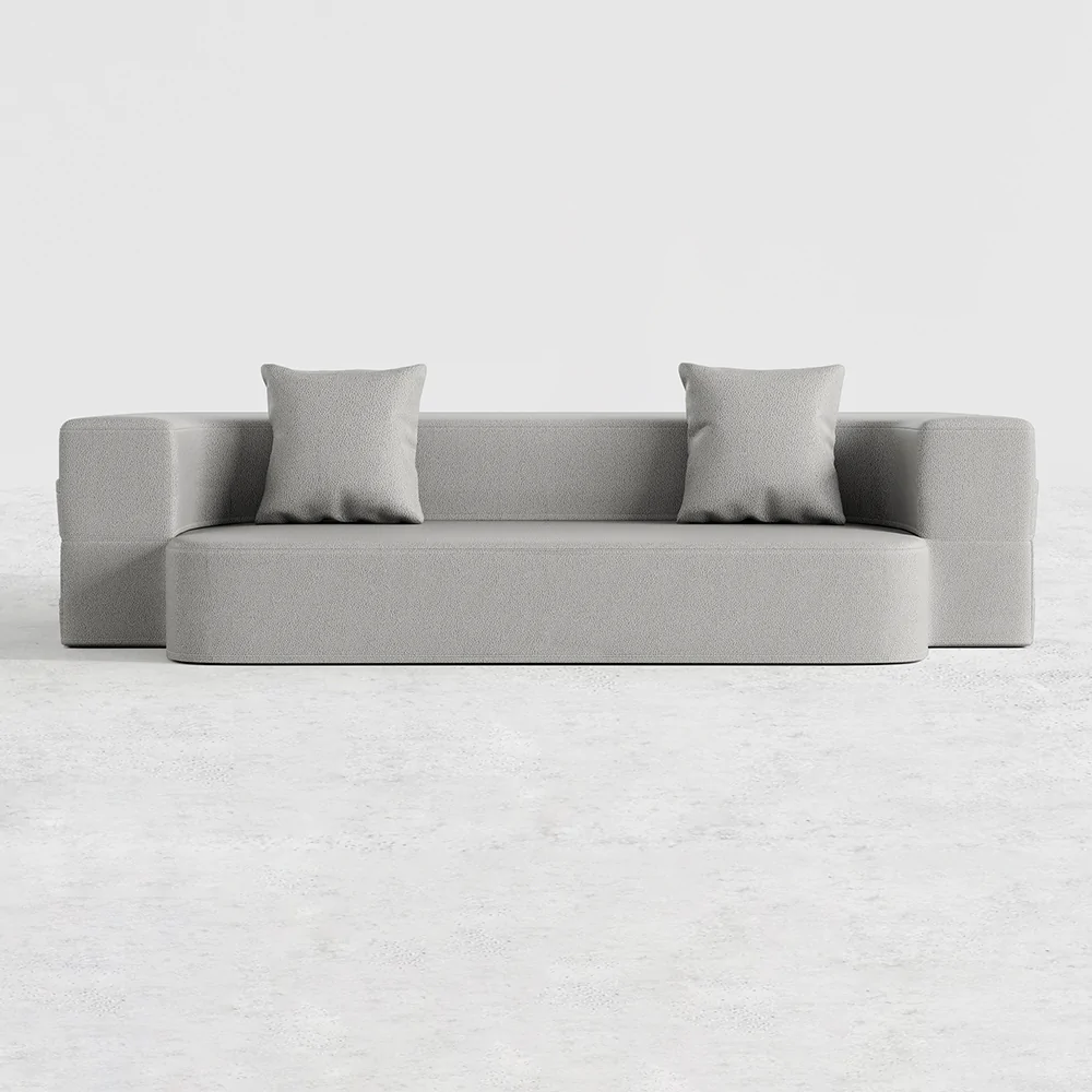 Sofá cama Hina de Hanabi Living en color gris, con cojines decorativos y estructura moderna para espacios pequeños.